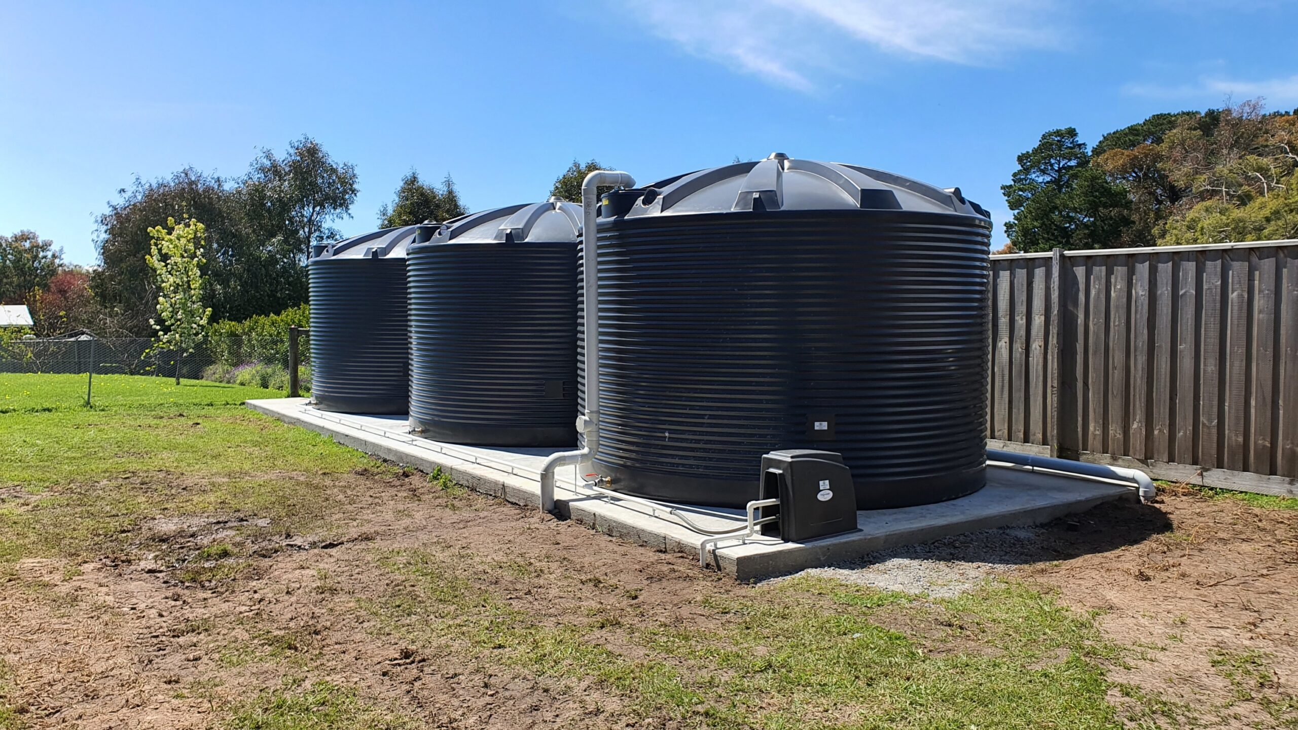 Round poly rainwater tanks installed on an Australian property